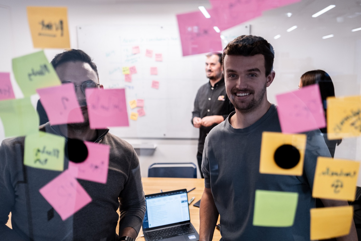 Planning sprint with sticky notes on glass, corporate workshop, London