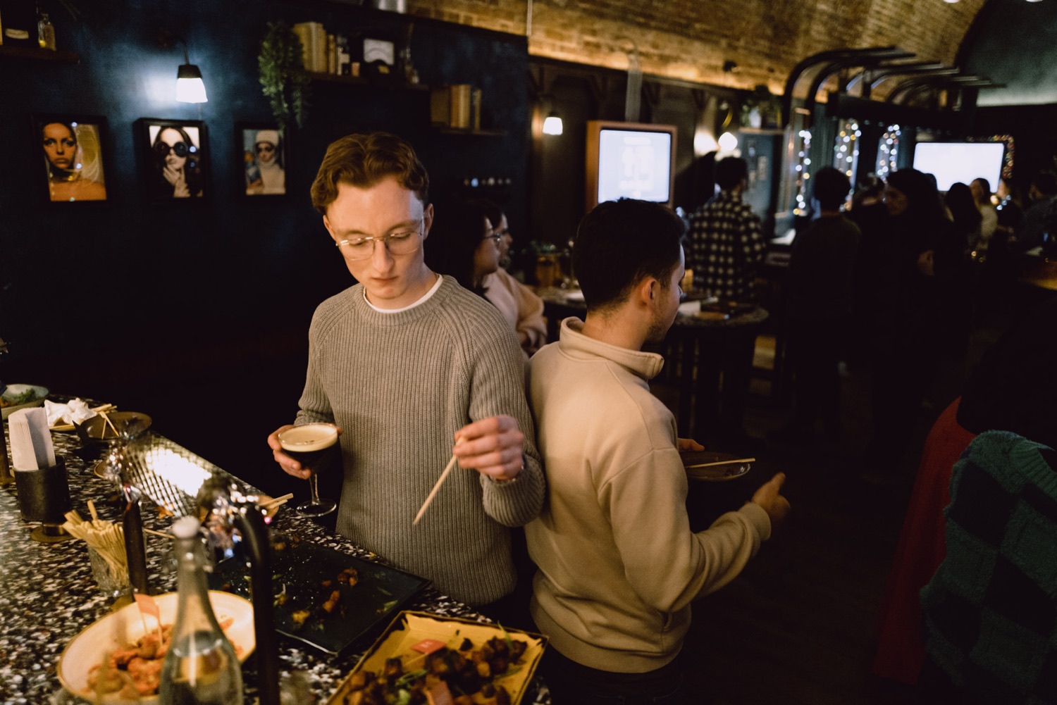 Guests at the food table during a company social, London