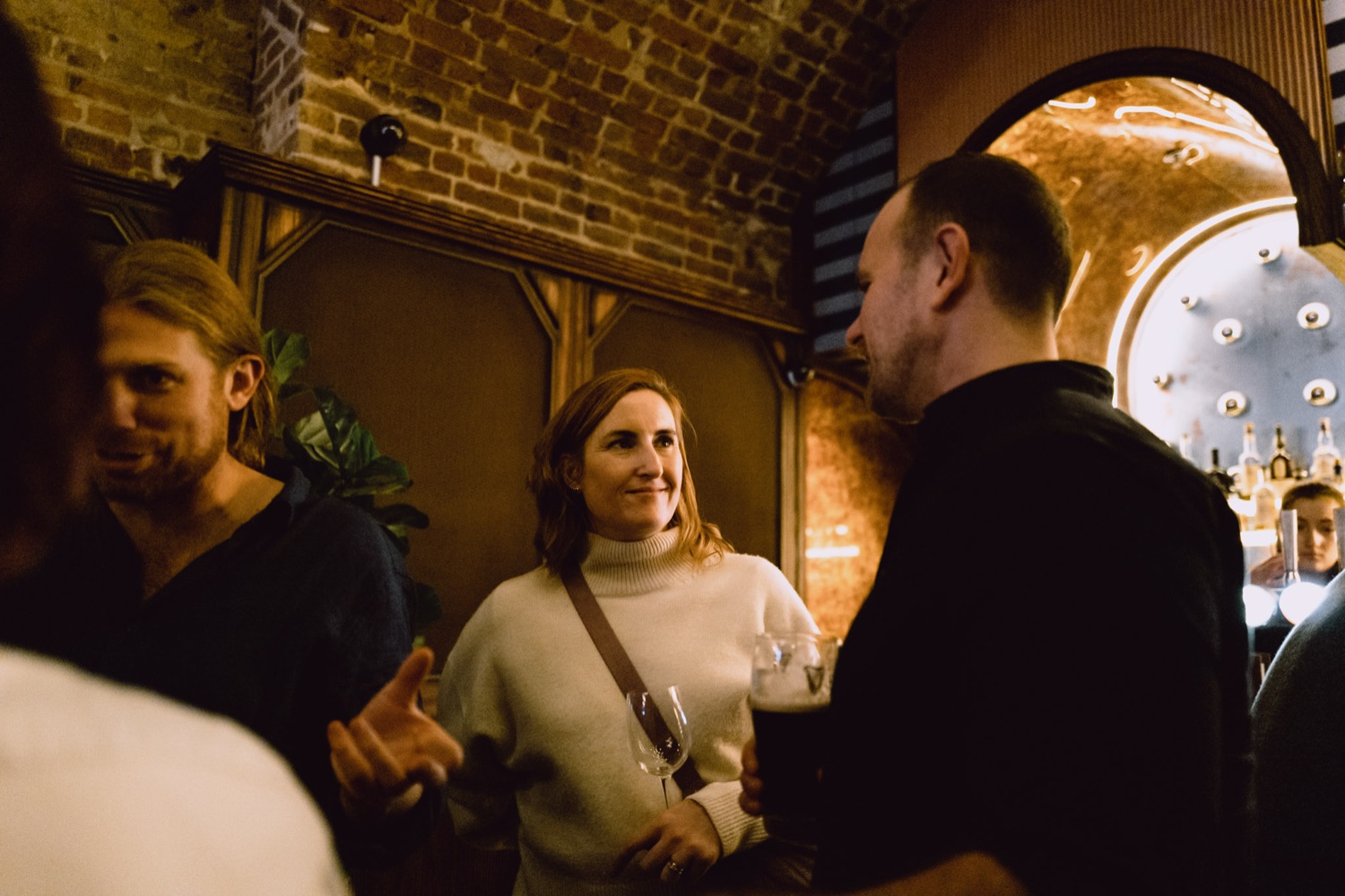 Conversation between colleagues at a company party, London