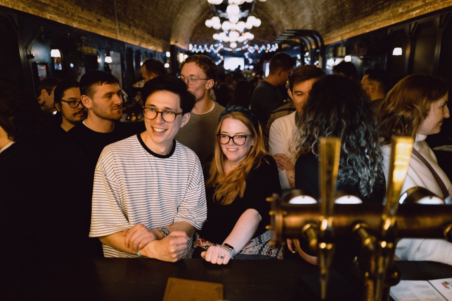 Colleagues at the bar during an office celebration, London