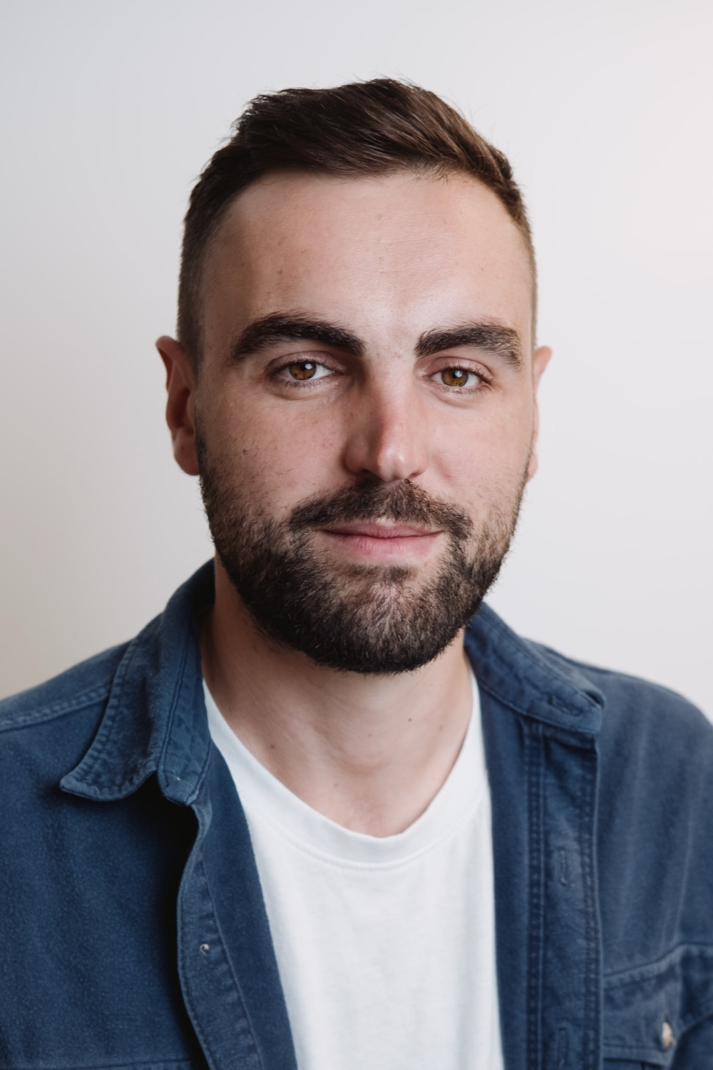 Corporate headshot session — relaxed expression, neutral backdrop, London