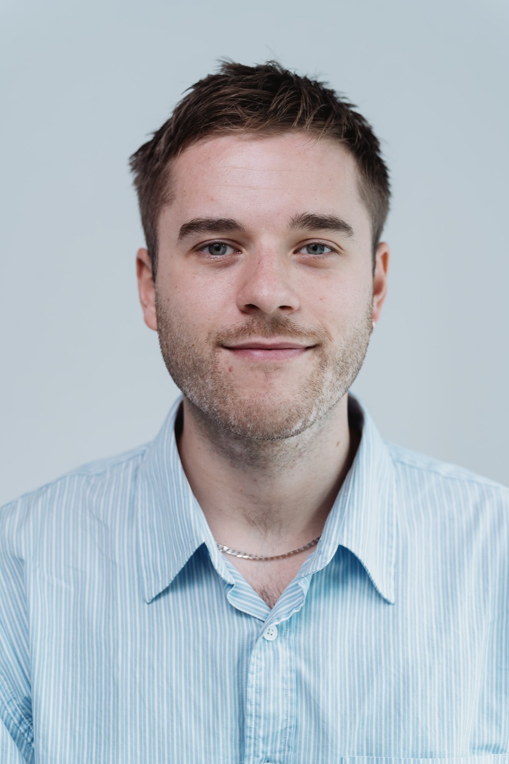 Team member headshot against a clean backdrop, on-site session, London