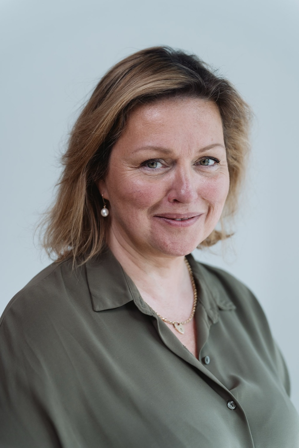 Corporate headshot with a warm, approachable expression, London